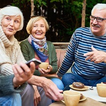 Friends chatting and snacking on an outdoor patio