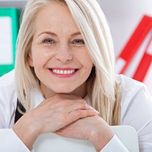 Woman with a bridge and crowns smiling.