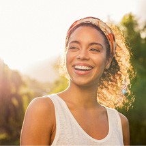 a woman smiling after root canal therapy in Tomball