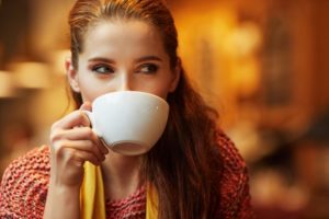 A woman drinking coffee.