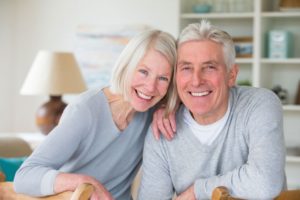 elderly couple smiling with dental implants in Tomball 