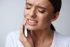 Woman with dental pain needing a dentist in Tomball.