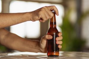 Man drinking alcohol after a tooth extraction