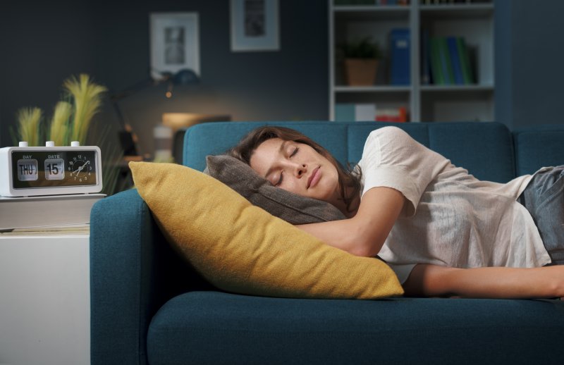 person resting on couch after getting a root canal