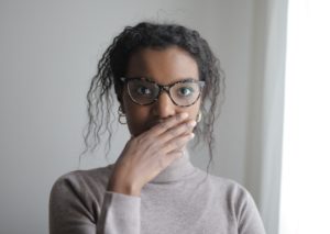 Woman covering her mouth with hand