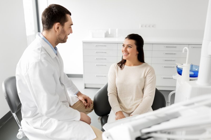 dentist talking to patient about oral bacteria