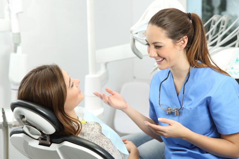 patient learning about root canal myths from dentist